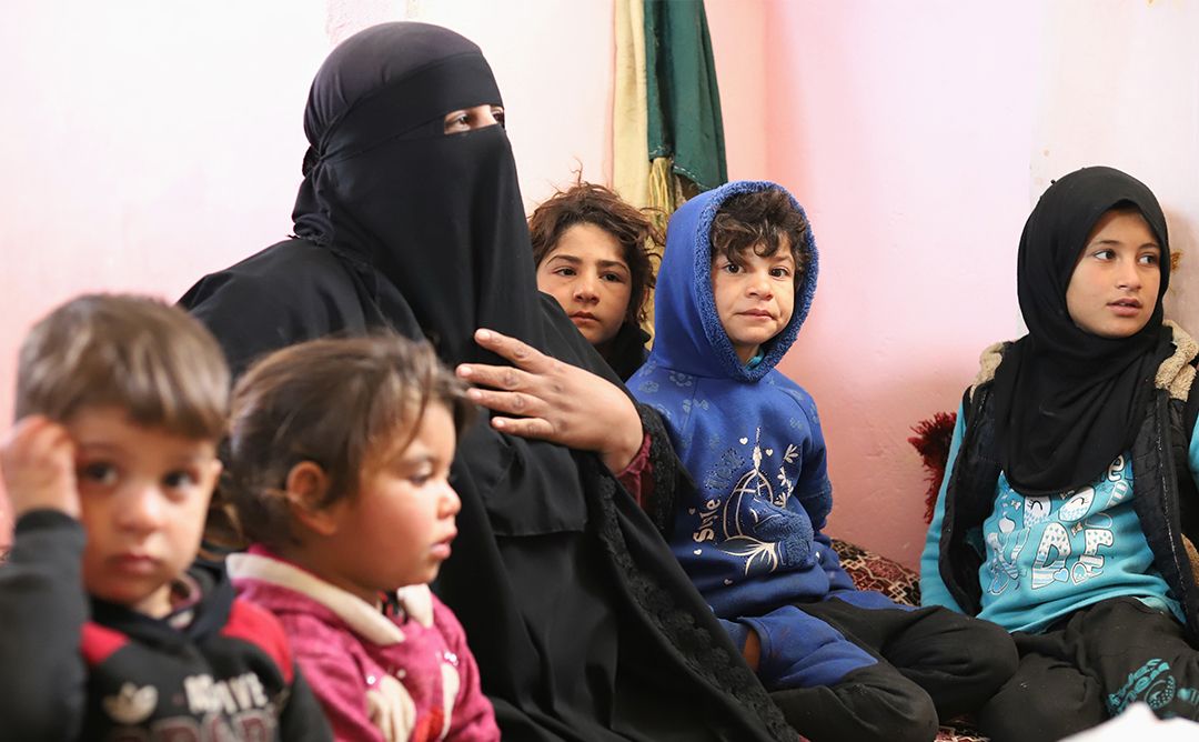 A woman in Syria sitting with her children and grandchildren inside a shelter for displaced family in Idleb Northwest Syria.